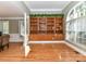 Spacious living room featuring built-in shelves and hardwood floors at 7012 Chadwyck Farms Dr, Charlotte, NC 28226