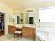 Main bathroom featuring double sinks, a soaking tub, and a walk-in closet for ample storage at 7012 Chadwyck Farms Dr, Charlotte, NC 28226