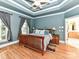 Luxurious main bedroom featuring blue walls, hardwood floors, and a tray ceiling with a ceiling fan at 7012 Chadwyck Farms Dr, Charlotte, NC 28226