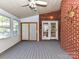 Enclosed sun room with multiple windows, brick wall, and access to the yard at 7012 Chadwyck Farms Dr, Charlotte, NC 28226