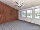 Cozy sun room with brick accent wall, multiple windows, and ample sunlight at 7012 Chadwyck Farms Dr, Charlotte, NC 28226
