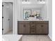 Elegant bathroom featuring a double vanity with dark wood cabinets and modern fixtures at 7105 Short Stirrup Ln, Mint Hill, NC 28227