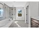 Modern bathroom featuring a soaking tub, glass shower, and window with a view at 7105 Short Stirrup Ln, Mint Hill, NC 28227