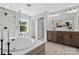 Luxurious bathroom with a soaking tub, double vanity, and a separate glass-enclosed shower at 7105 Short Stirrup Ln, Mint Hill, NC 28227