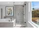 Modern bathroom boasting soaking tub and glass enclosed shower with rainfall shower head at 7105 Short Stirrup Ln, Mint Hill, NC 28227
