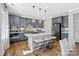 Spacious kitchen featuring an island with seating, gray cabinets, and stainless steel appliances at 7105 Short Stirrup Ln, Mint Hill, NC 28227