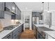Contemporary kitchen with gray cabinets, a pantry, stainless steel appliances, and elegant countertops at 7105 Short Stirrup Ln, Mint Hill, NC 28227