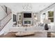 Cozy living room with a stone fireplace, large windows, and comfortable seating arrangement at 7105 Short Stirrup Ln, Mint Hill, NC 28227