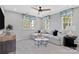 Bright living room with a comfortable sectional couch and a modern ceiling fan at 7105 Short Stirrup Ln, Mint Hill, NC 28227