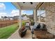 Relaxing outdoor patio with comfortable seating and a view of the backyard and neighboring homes at 7105 Short Stirrup Ln, Mint Hill, NC 28227