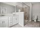 Bathroom features a double sink vanity, tiled floors, and a frameless shower at 7117 Brookview Ln, Sherrills Ford, NC 28673