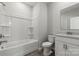 Bright bathroom featuring a shower-tub combo, toilet and vanity with granite countertop at 7117 Brookview Ln, Sherrills Ford, NC 28673