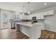 Bright kitchen features white cabinets, quartz countertops, stainless appliances, and a large center island at 7117 Brookview Ln, Sherrills Ford, NC 28673