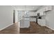Bright kitchen features white cabinets, gray backsplash, stainless appliances, and a large center island at 7117 Brookview Ln, Sherrills Ford, NC 28673