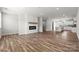 Spacious open-concept living room with fireplace, hardwood floors and kitchen in the background at 7117 Brookview Ln, Sherrills Ford, NC 28673