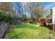 Green backyard featuring a wooden deck, shed and chain link fence at 713 8Th Street Nw Dr, Hickory, NC 28601