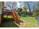 Fenced backyard with a wooden deck and storage shed with mature trees overhead at 713 8Th Street Nw Dr, Hickory, NC 28601