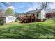 Spacious backyard features a deck, mature trees, green grass and a fenced perimeter at 713 8Th Street Nw Dr, Hickory, NC 28601
