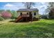 Backyard with a fenced perimeter, wooden deck, grassy area and storage shed at 713 8Th Street Nw Dr, Hickory, NC 28601