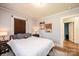 Cozy bedroom featuring a queen-size bed, neutral walls, wood floors and an open doorway at 713 8Th Street Nw Dr, Hickory, NC 28601