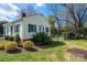 Yellow house with green shutters, brick chimney and established landscaping at 713 8Th Street Nw Dr, Hickory, NC 28601