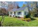 Quaint home with blooming tree in front yard and well-kept lawn at 713 8Th Street Nw Dr, Hickory, NC 28601