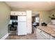 Well-equipped kitchen with stainless steel appliances and tiled floors, offering a functional layout at 713 8Th Street Nw Dr, Hickory, NC 28601