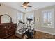 This bedroom features hardwood floors, neutral walls, exercise equipment, and plantation shutters at 727 Bluff Loop Rd, Rock Hill, SC 29730