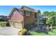 Exterior view of this red home with a two-car garage and backyard patio and landscaping at 727 Bluff Loop Rd, Rock Hill, SC 29730