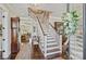 Elegant foyer with a staircase, hardwood floors, and decorative accents creating a warm and inviting entrance at 727 Bluff Loop Rd, Rock Hill, SC 29730
