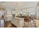 A spacious kitchen with a center island and stainless steel double oven leading into the living room at 727 Bluff Loop Rd, Rock Hill, SC 29730