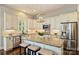 Modern kitchen featuring white cabinets, a granite island, and stainless steel appliances at 727 Bluff Loop Rd, Rock Hill, SC 29730