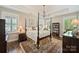 Spacious main bedroom featuring a four-poster bed, elegant chandelier, and bright windows at 727 Bluff Loop Rd, Rock Hill, SC 29730