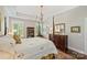 Bright main bedroom boasts a four-poster bed, large windows, and decorative touches at 727 Bluff Loop Rd, Rock Hill, SC 29730