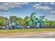 Community playground with colorful climbing structures and slides, surrounded by trees at 727 Bluff Loop Rd, Rock Hill, SC 29730