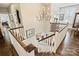 A staircase with white railings and wood accents, illuminated by a chandelier at 727 Bluff Loop Rd, Rock Hill, SC 29730