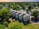 Aerial view of condo community surrounded by mature trees and parking lots at 7829 Village Harbor Dr, Cornelius, NC 28031