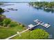 Aerial view of waterfront property with docks, boats, lush greenery, and picturesque Lake Norman at 7829 Village Harbor Dr, Cornelius, NC 28031