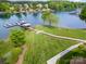 Expansive waterfront estate with a long boardwalk leading to boat docks on the serene waters of Lake Norman at 7829 Village Harbor Dr, Cornelius, NC 28031