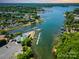Expansive aerial view of lake community with lush trees and boat docks at 7829 Village Harbor Dr, Cornelius, NC 28031