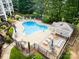 Aerial view of the sparkling community pool with lounge chairs and umbrellas for resident relaxation at 7829 Village Harbor Dr, Cornelius, NC 28031