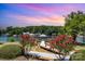 Scenic view of the dock featuring vibrant red plants and colorful skies above Lake Norman at 7829 Village Harbor Dr, Cornelius, NC 28031