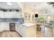 Well-lit kitchen featuring a breakfast bar, stainless steel appliances, and an open layout at 7829 Village Harbor Dr, Cornelius, NC 28031