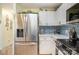 Bright kitchen features stainless steel appliances, white cabinetry, and subway tile backsplash at 7829 Village Harbor Dr, Cornelius, NC 28031