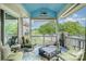 Relaxing screened-in patio features comfortable seating and stunning lake views at 7829 Village Harbor Dr, Cornelius, NC 28031