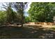 Large backyard surrounded by woods and a wooden fence at 8722 Moody Rd, Charlotte, NC 28215