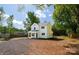 Charming two-story home with a gravel driveway and a well-manicured lawn and mature trees at 8722 Moody Rd, Charlotte, NC 28215