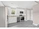 This kitchen is has stainless appliances, granite countertops, white subway tile, and gray wood-look floors at 8722 Moody Rd, Charlotte, NC 28215