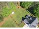 Aerial view of the backyard showing a manicured lawn with a fire pit and fenced area at 921 Snow Prince Ln, York, SC 29745
