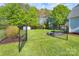 Chain link fenced backyard features a fire pit, lawn and storage shed at 921 Snow Prince Ln, York, SC 29745